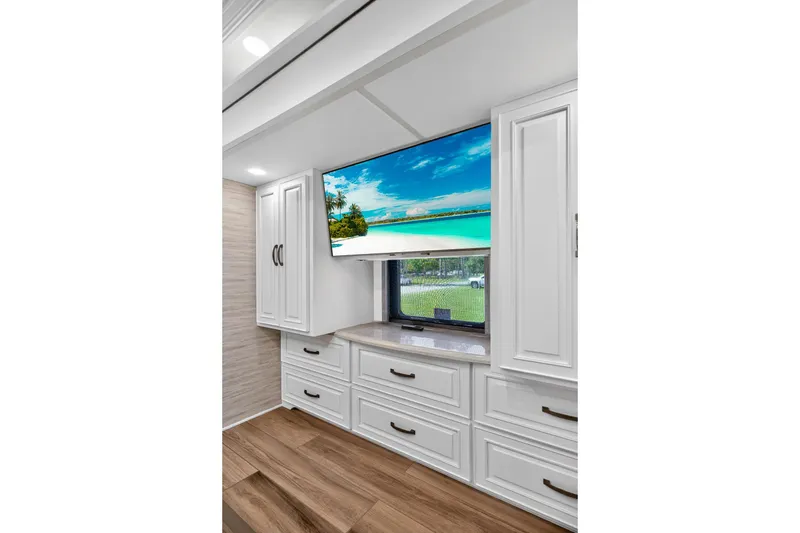 Slide: The Image of Luxurious interior of 2025 Newmar Dutch Star 4340 RV with elegant cabinetry and modern TV. - 25