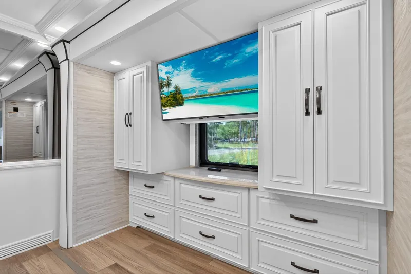 Slide: The Image of Luxurious interior of 2025 Newmar Dutch Star 4340 RV with elegant cabinetry and mounted TV. - 26