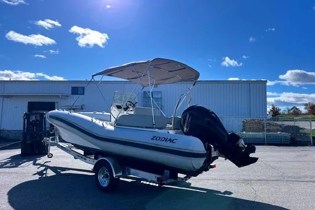 Slide: The Image of 2023 Zodiac N-ZO 680 boat on trailer under clear blue sky. - 11