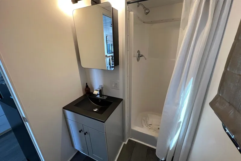 Slide: The Image of Modern bathroom in 2019 Catamaran Cruisers houseboat with shower and vanity. - 10