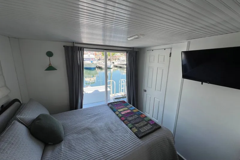 Slide: The Image of Cozy bedroom in 2019 Catamaran Cruisers houseboat with marina view. - 12