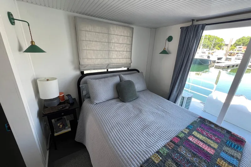 Slide: The Image of Cozy bedroom in a 2019 Catamaran Cruisers houseboat with marina view. - 13