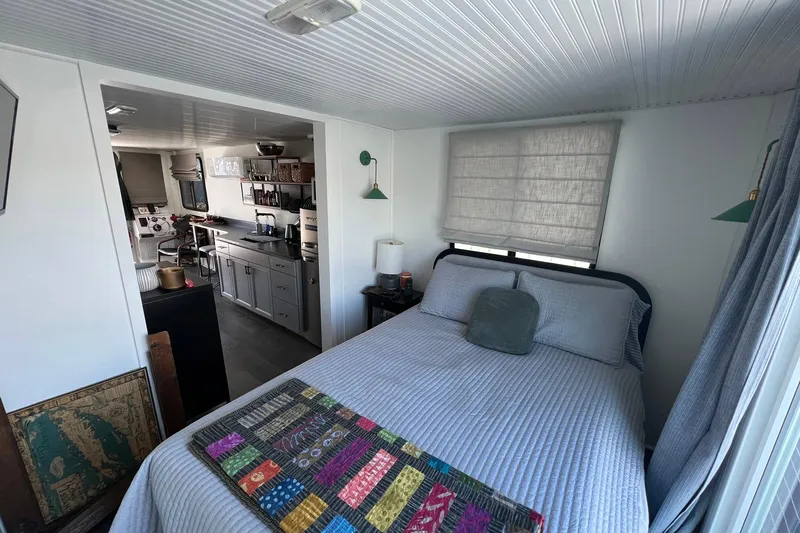Slide: The Image of Interior of 2019 Catamaran Cruisers houseboat with cozy bedroom and modern kitchen. - 14