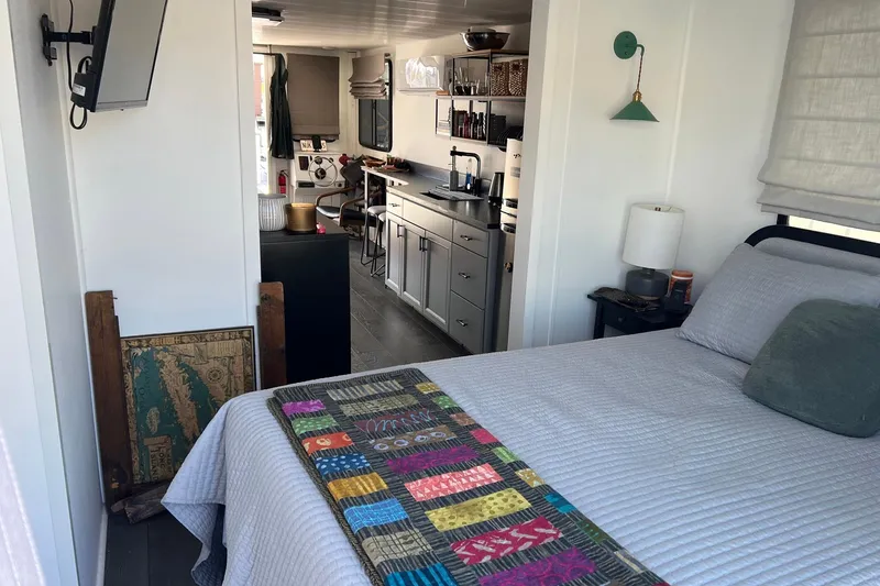 Slide: The Image of Interior of a 2019 Catamaran Cruisers houseboat with cozy bedroom and modern kitchen. - 18