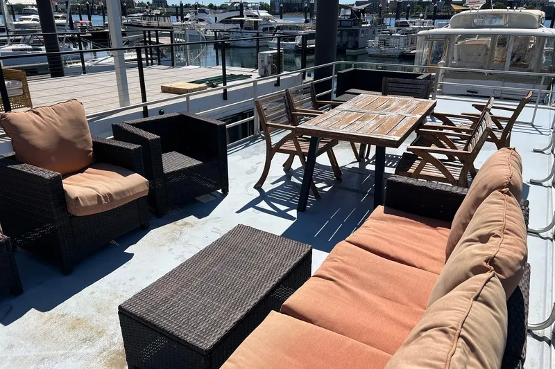 Slide: The Image of 2019 Catamaran Cruisers House Boat deck with outdoor seating and dining area. - 21