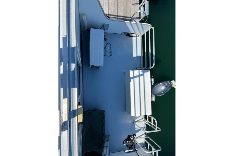 Slide: The Image of 2019 Catamaran Cruisers House Boat deck with railing and outboard motor. - 22