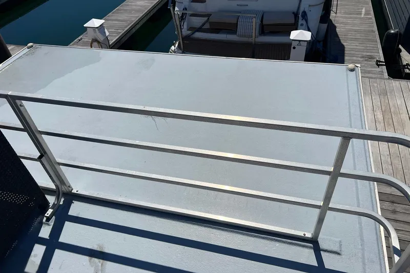 Slide: The Image of 2019 Catamaran Cruisers House Boat deck with railing at marina. - 23