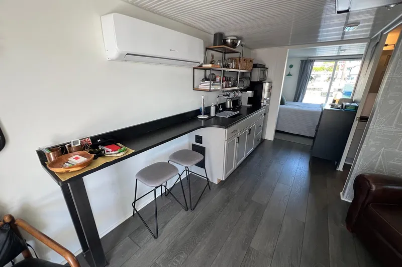 Slide: The Image of Modern interior of a 2019 Catamaran Cruisers houseboat with kitchen and seating area. - 4