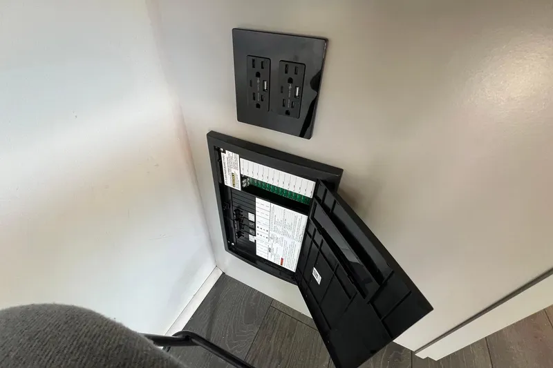 Slide: The Image of Electrical panel and outlet on 2019 Catamaran Cruisers houseboat interior wall. - 5