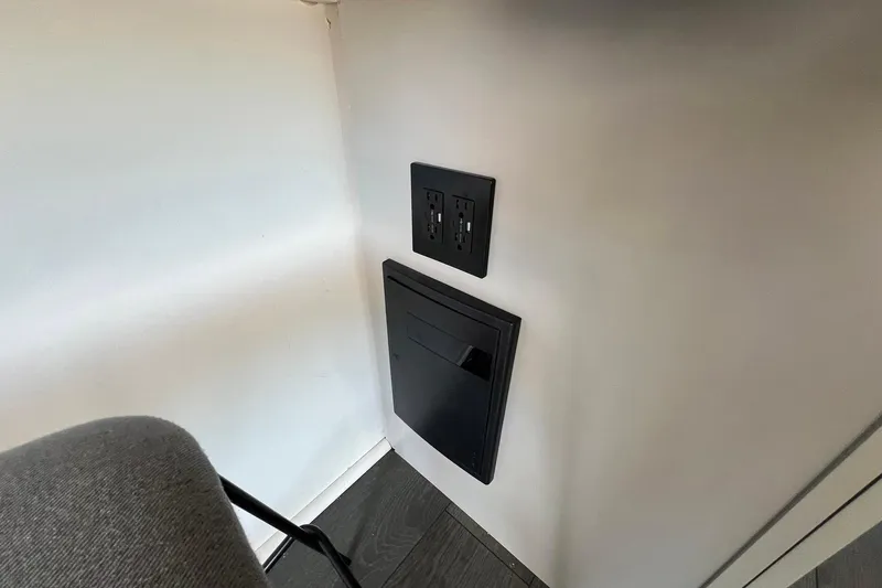 Slide: The Image of Power outlet and panel on 2019 Catamaran Cruisers houseboat interior wall. - 6
