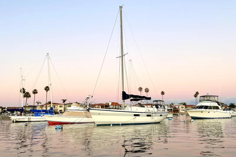 The Image of Sailboats anchored at sunset, featuring a 1972 Coronado Yachts 35 Center Cockpit. - 0