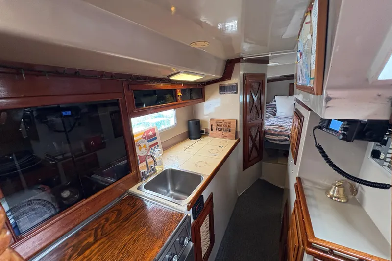 Slide: The Image of Interior of 1972 Coronado Yachts 35 Center Cockpit with cozy kitchen and sleeping area. - 19