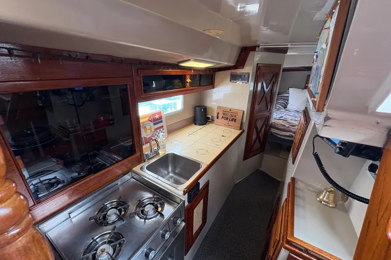 Slide: The Image of Interior of 1972 Coronado Yachts 35 Center Cockpit with kitchen and cozy sleeping area. - 21