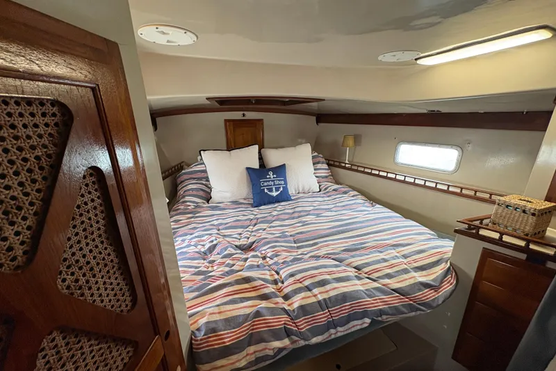 Slide: The Image of Cozy cabin interior of 1972 Coronado Yachts 35 Center Cockpit with striped bedding. - 23