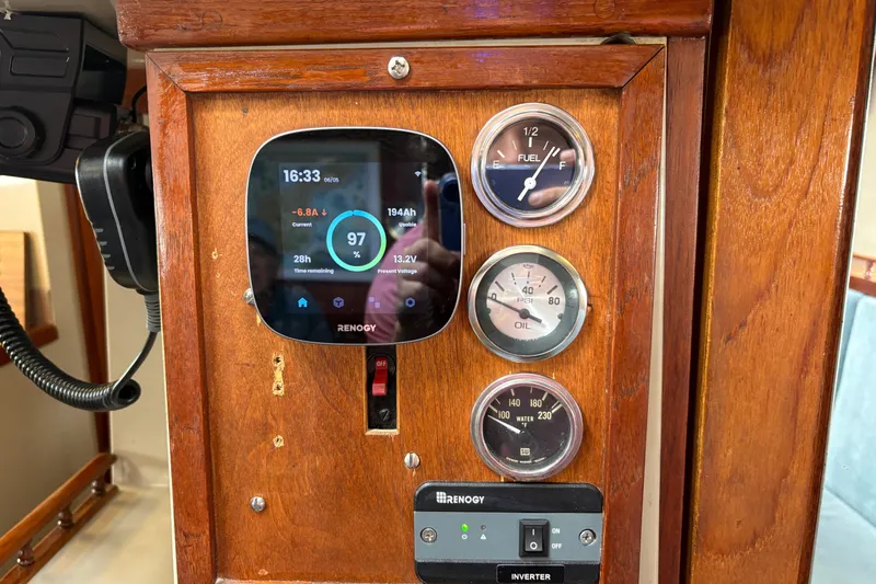 Slide: The Image of Control panel of a 1972 Coronado Yachts 35 Center Cockpit with Renogy display and gauges. - 29