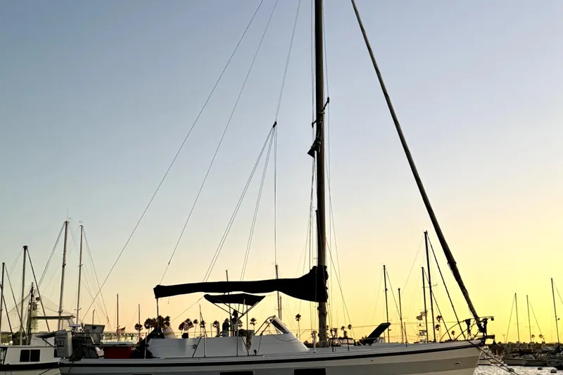 Slide: The Image of 1972 Coronado Yachts 35 Center Cockpit sailboat at sunset in marina. - 3