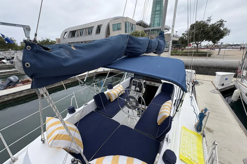 Slide: The Image of 1972 Coronado Yachts 35 Center Cockpit sailboat docked, featuring blue and yellow seating. - 8