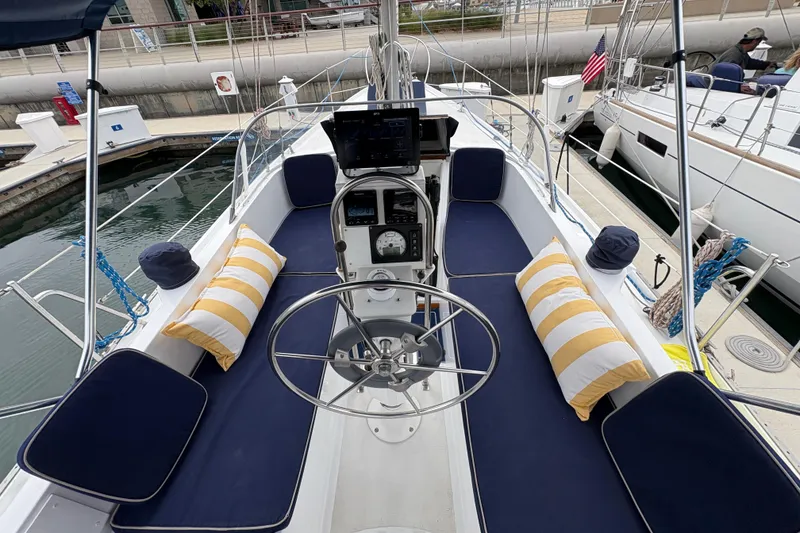 Slide: The Image of 1972 Coronado Yachts 35 Center Cockpit with blue cushions and striped pillows at dock. - 9