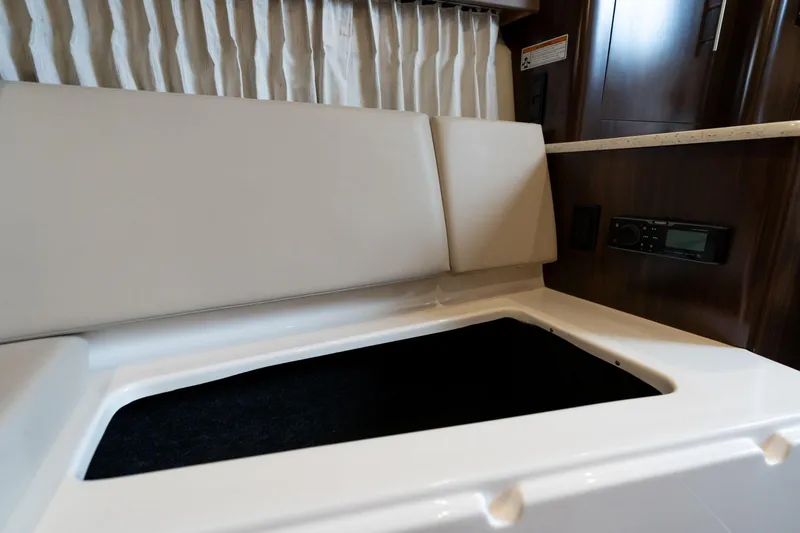 Slide: The Image of Interior seating and storage of 2016 Regal 28 Express boat. - 12