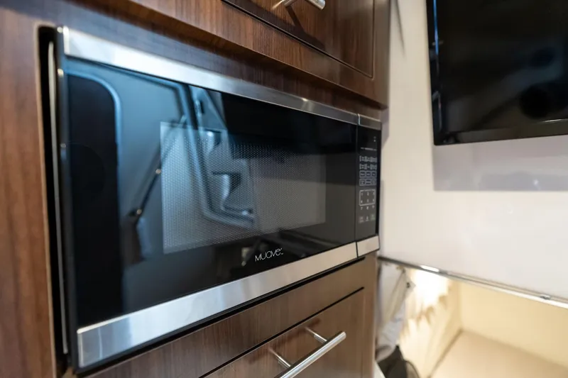 Slide: The Image of Built-in microwave in 2016 Regal 28 Express boat interior kitchen area. - 15