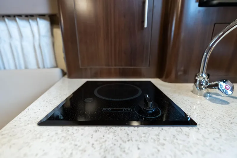 Slide: The Image of Modern stovetop in 2016 Regal 28 Express yacht kitchen. - 17