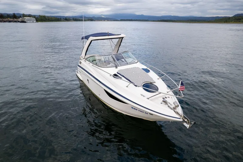 Slide: The Image of 2016 Regal 28 Express boat on calm water with American flag. - 2