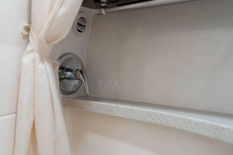 Slide: The Image of 2016 Regal 28 Express boat interior shower with curtain and faucet. - 25