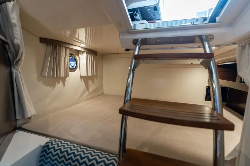 Slide: The Image of Interior cabin of 2016 Regal 28 Express boat with wooden ladder and porthole window. - 27