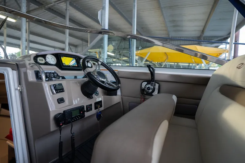 Slide: The Image of 2016 Regal 28 Express boat cockpit with steering wheel and control panel. - 29