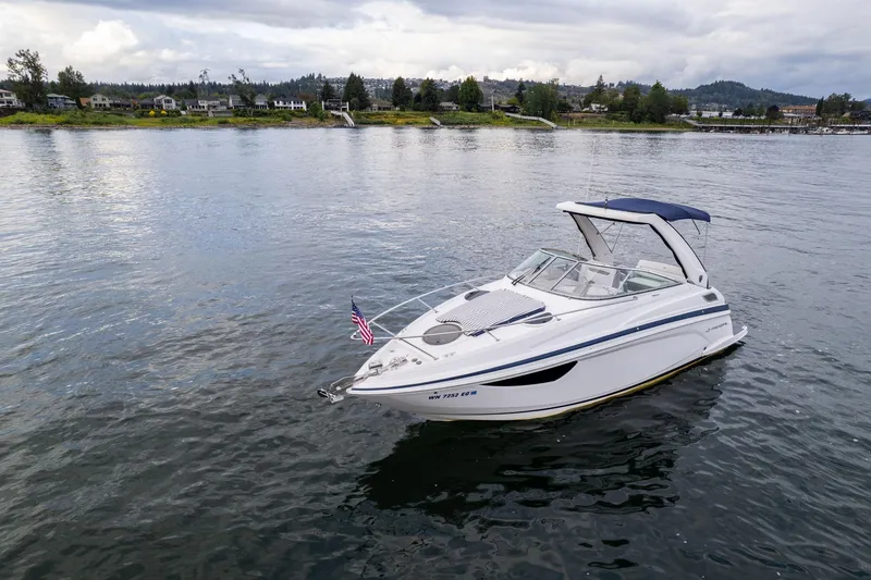 Slide: The Image of 2016 Regal 28 Express boat on calm water with scenic shoreline background. - 3