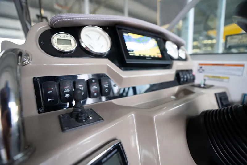 Slide: The Image of 2016 Regal 28 Express boat dashboard with gauges and navigation display. - 32