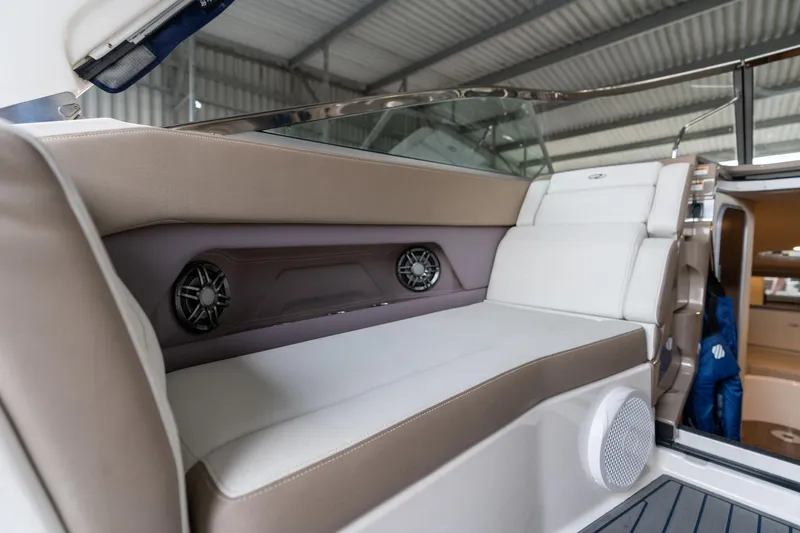 Slide: The Image of 2016 Regal 28 Express boat interior with cushioned seating and built-in speakers. - 40