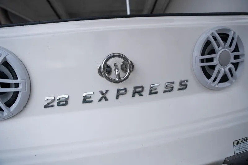 Slide: The Image of 2016 Regal 28 Express boat rear view with speakers and logo. - 45