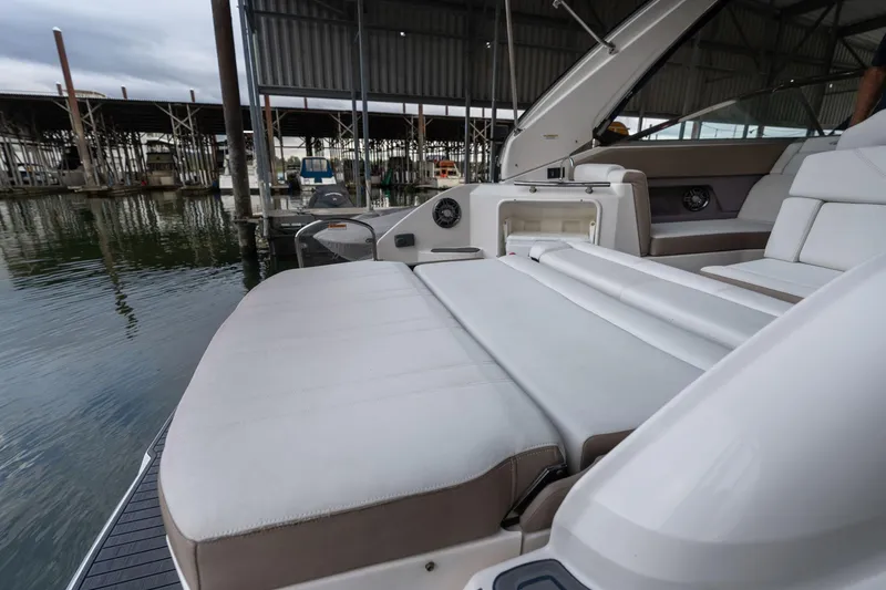 Slide: The Image of 2016 Regal 28 Express boat with spacious seating at a marina dock. - 49
