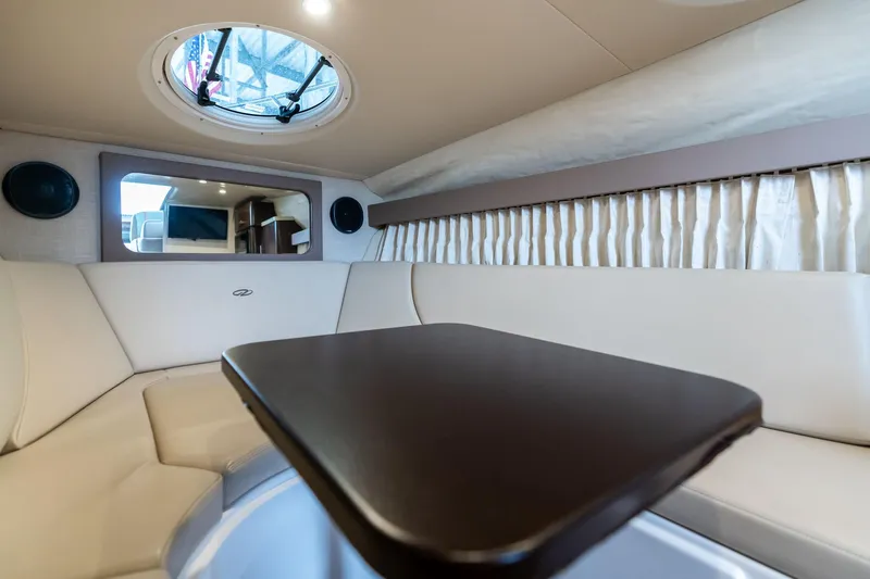 Slide: The Image of 2016 Regal 28 Express cabin interior with seating, table, and porthole. - 7