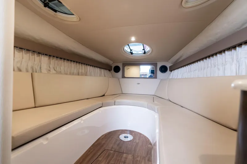 Slide: The Image of 2016 Regal 28 Express cabin interior with beige seating and wood flooring. - 8