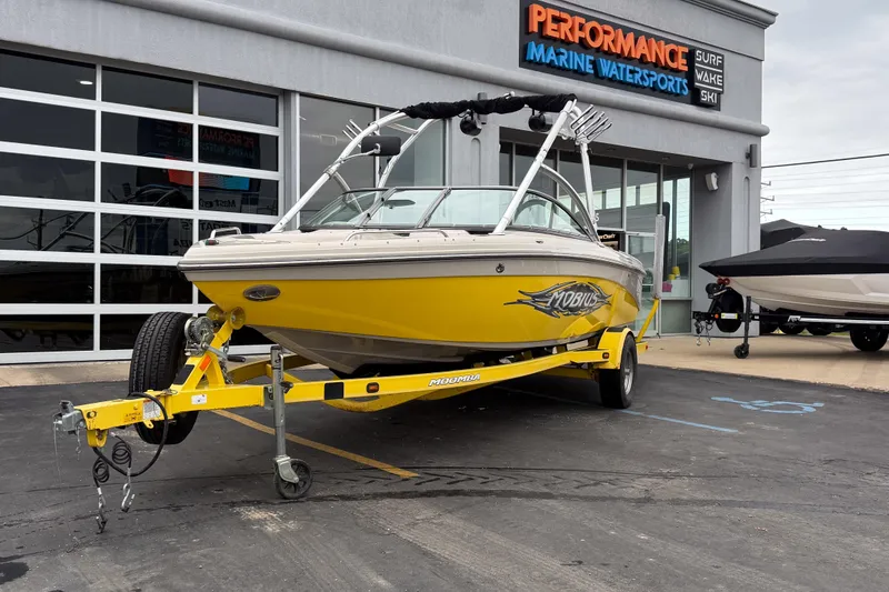 The Image of 2008 Moomba Mobius LSV boat in yellow on trailer at marine dealership. - 1