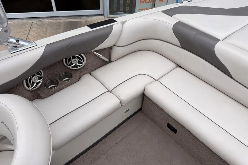 Slide: The Image of 2008 Moomba Mobius LSV boat interior with white and gray seating, cup holders, and speakers. - 12