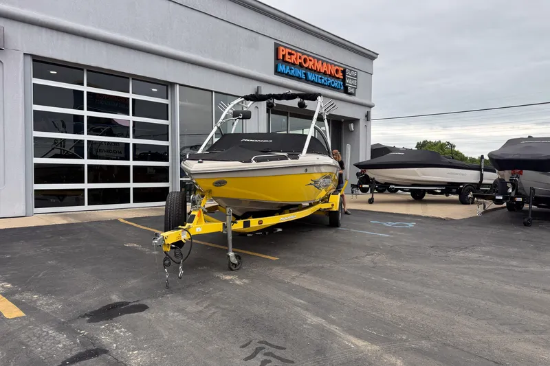 Slide: The Image of 2008 Moomba Mobius LSV boat in yellow, parked outside Performance Marine Watersports. - 19