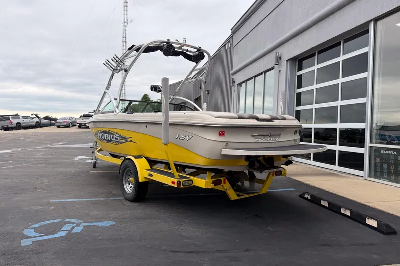 Slide: The Image of 2008 Moomba Mobius LSV boat in yellow, parked outside a dealership. - 4