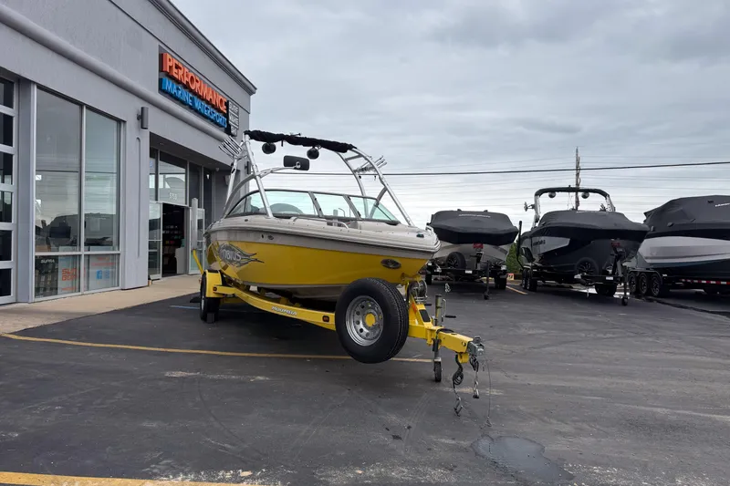 Slide: The Image of 2008 Moomba Mobius LSV boat in yellow, parked outside Performance Marine Watersports. - 8