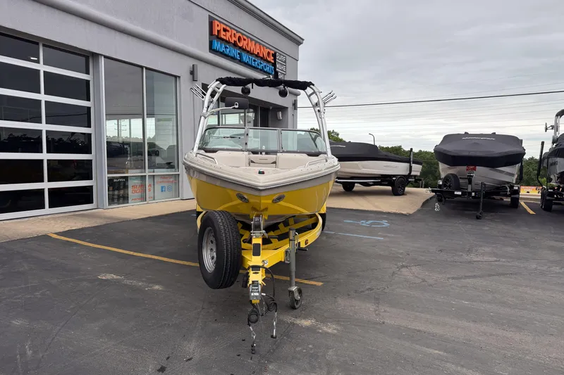 Slide: The Image of 2008 Moomba Mobius LSV boat in yellow, parked outside Performance Marine Watersports. - 9