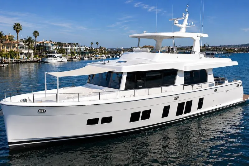 The Image of Luxury 2027 Offshore Yachts 70 CE cruising in a scenic marina setting. - 1