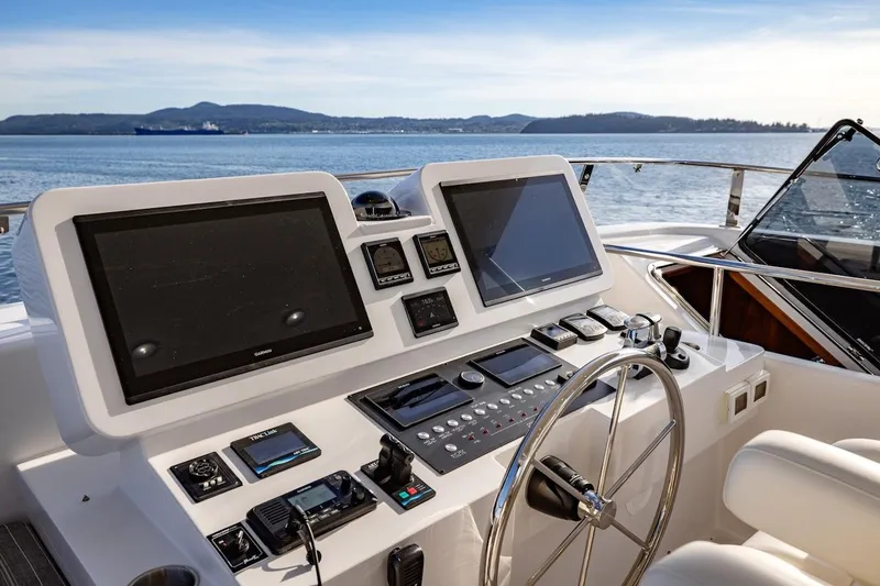 Slide: The Image of Helm of 2027 Offshore Yachts 70 CE with dual screens and navigation controls. - 11