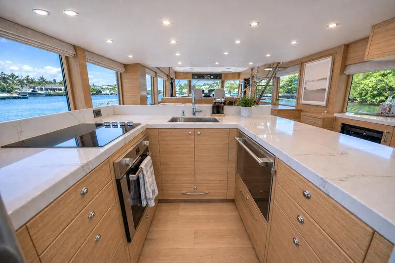 Slide: The Image of Luxurious kitchen interior of 2027 Offshore Yachts 70 CE with modern appliances and scenic views. - 16