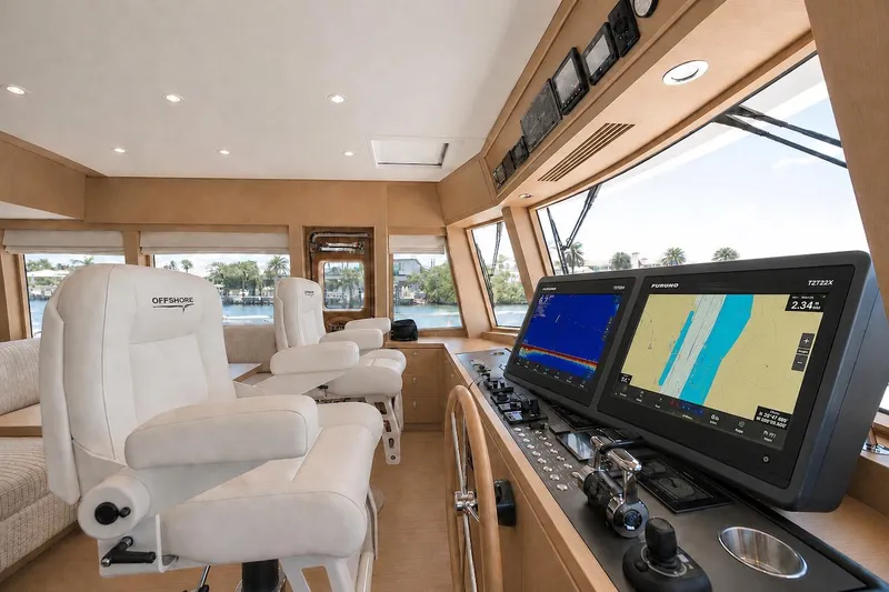 Slide: The Image of Luxurious helm of 2027 Offshore Yachts 70 CE with advanced navigation displays and plush seating. - 17