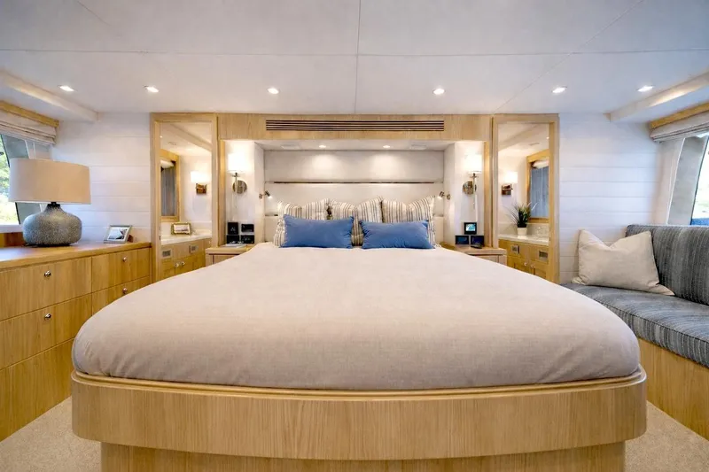 Slide: The Image of Luxurious bedroom interior of 2027 Offshore Yachts 70 CE, featuring elegant wood finishes and modern decor. - 18