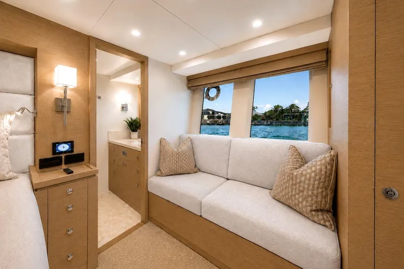 Slide: The Image of Luxurious interior of 2027 Offshore Yachts 70 CE, featuring elegant seating and scenic window view. - 20