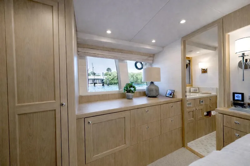 Slide: The Image of Luxurious interior of 2027 Offshore Yachts 70 CE, featuring elegant wood cabinetry and modern decor. - 21