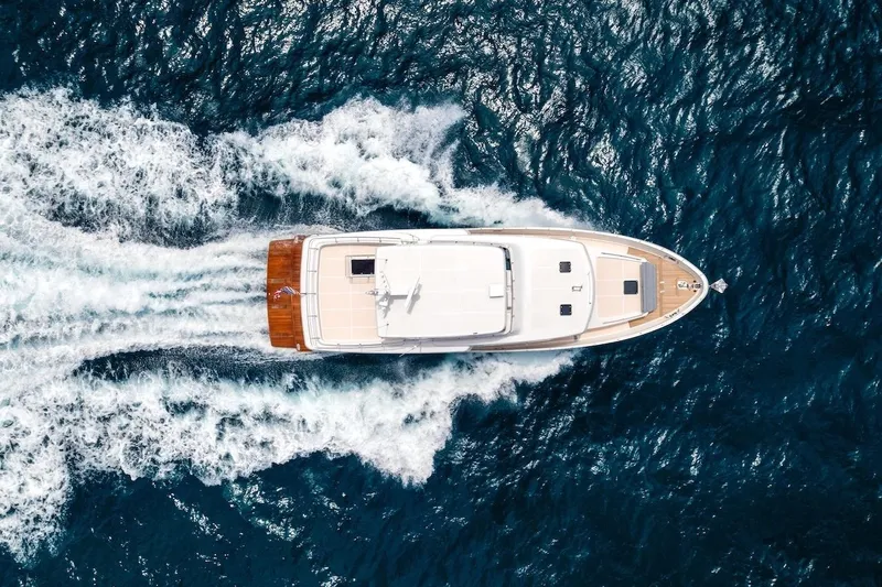 Slide: The Image of Aerial view of 2027 Offshore Yachts 70 CE cruising through ocean waves. - 4